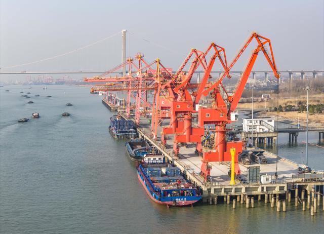 (260114) -- BEIJING, Jan. 14, 2026 (Xinhua) -- An aerial drone photo taken on Jan. 14, 2026 shows cargo ships loading and unloading containers at a container terminal of Taizhou Port in Taizhou, east China's Jiangsu Province. Last year, China's foreign trade value hit 45.47 trillion yuan (about 6.48 trillion U.S. dollars), up 3.8 percent year on year, according to data released by the General Administration of Customs on Wednesday. This marks the ninth consecutive year of growth for China's foreign trade since 2017. (Photo by Zhou Shegen/Xinhua)