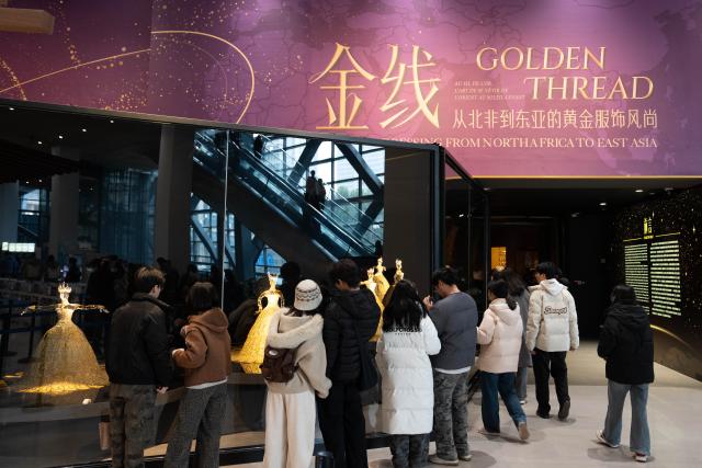 (260114) -- CHENGDU, Jan. 14, 2026 (Xinhua) -- People visit the exhibition "Golden Thread: the Art of Dressing from North Africa to East Asia" at the Chengdu Museum in Chengdu, southwest China's Sichuan Province, Jan. 13, 2026. The exhibition features over 200 pieces (sets) of gold-threaded textile artifacts from seven French cultural institutions, alongside precious collections from eight Chinese museums and cultural heritage organizations. (Xinhua/Xu Bingjie)
