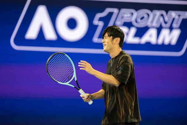 (260114) -- MELBOURNE, Jan. 14, 2026 (Xinhua) -- Chinese pop singer Jay Chou reacts during the 1 point slam event against Petar Jovic of Australia at Australian Open tennis tournament in Melbourne, Australia, Jan. 14, 2026. (Photo by Hu Jingchen/Xinhua)