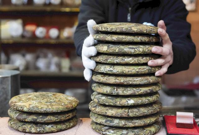 (260114) -- PU'ER, Jan. 14, 2026 (Xinhua) -- This photo taken on Jan. 14, 2026 shows Pu'er tea products in Nakeli Village, in Hani and Yi Autonomous County of Ning'er, Pu'er City, southwest China's Yunnan Province. The village of Nakeli, previously witnessed boisterous camel caravans carrying sacks of tea leaves while winding through ancient China's vast western area all the way to Southeast Asia and the Middle East. Today, the village has become a popular winter travel destination for tourists, thanks to its unique Tea Horse Road culture and pleasant climate. Besides visiting historical sites, tourists can also immerse themselves in activities such as making Pu'er tea products, retracing ancient paths on horseback, and tasting intangible cultural heritage cuisine. (Xinhua/Chen Xinbo)