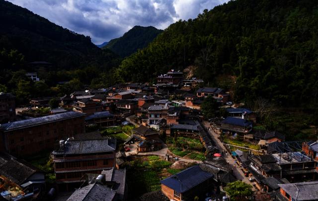 (260114) -- PU'ER, Jan. 14, 2026 (Xinhua) -- A drone photo taken on Jan. 14, 2026 shows a view of Nakeli Village, in Hani and Yi Autonomous County of Ning'er, Pu'er City, southwest China's Yunnan Province. The village of Nakeli, previously witnessed boisterous camel caravans carrying sacks of tea leaves while winding through ancient China's vast western area all the way to Southeast Asia and the Middle East. Today, the village has become a popular winter travel destination for tourists, thanks to its unique Tea Horse Road culture and pleasant climate. Besides visiting historical sites, tourists can also immerse themselves in activities such as making Pu'er tea products, retracing ancient paths on horseback, and tasting intangible cultural heritage cuisine. (Xinhua/Chen Xinbo)