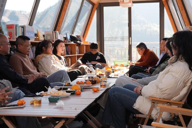 (260114) -- QUZHOU, Jan. 14, 2026 (Xinhua) -- People take part in a cultural salon in Lulikeng Village of Changshan County, east China's Zhejiang Province, Jan. 14, 2026. Lulikeng Village has renovated its abandoned lime kilns into rural tourism facilities in recent years, turning the village into a destination for tourists from surrounding areas. Since 2024, various business sectors in the village have enabled over 150 villagers to find jobs right at their doorstep, and increased the village's income by more than 6 million yuan (about 0.86 million U.S. dollars). (Xinhua/Weng Xinyang)