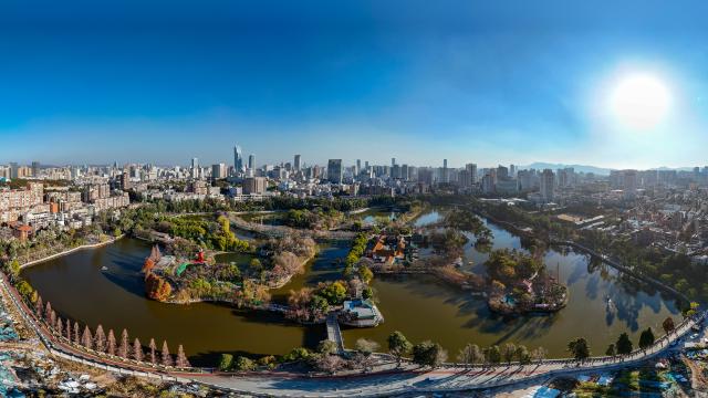 (260114) -- KUNMING, Jan. 14, 2026 (Xinhua) -- An aerial drone photo taken on Jan. 13, 2026 shows a view of Cuihu Lake in Kunming, southwest China's Yunnan Province. Cuihu Lake is both a signature landscape of Kunming and a testament to the city's memories, surrounded by historical legacies such as the former sites of the National Southwestern Associated University and Yunnan Military Academy.
   Much like other older urban neighborhoods, the vicinity of Cuihu Lake had grappled with diminishing business vitality. The pressing challenge lies in revitalizing these dormant streets while preserving their historical essence and avoiding extensive demolition and construction.
   In recent years, a "cultural corridor" has been created around the lake, linking scattered historical and cultural sites while capitalizing on the thriving coffee industry. Cafe-centered boutique retail businesses have been established along this corridor, shaping an inclusive public space where people can feel free to take a walk, enjoy coffee and immerse themselves in reading. This endeavor has successfully infused the old neighborhoods with new waves of consumption. "Going to the Cuihu Lake for coffee" is now trending among local residents and tourists alike. (Xinhua/Peng Yikai)