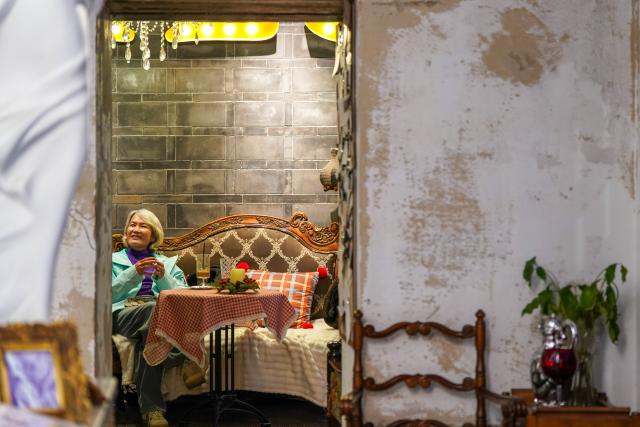 (260114) -- KUNMING, Jan. 14, 2026 (Xinhua) -- A tourist enjoys herself at a century-old coffee shop near Cuihu Lake in Kunming, southwest China's Yunnan Province, Jan. 13, 2026. Cuihu Lake is both a signature landscape of Kunming and a testament to the city's memories, surrounded by historical legacies such as the former sites of the National Southwestern Associated University and Yunnan Military Academy.
   Much like other older urban neighborhoods, the vicinity of Cuihu Lake had grappled with diminishing business vitality. The pressing challenge lies in revitalizing these dormant streets while preserving their historical essence and avoiding extensive demolition and construction.
   In recent years, a "cultural corridor" has been created around the lake, linking scattered historical and cultural sites while capitalizing on the thriving coffee industry. Cafe-centered boutique retail businesses have been established along this corridor, shaping an inclusive public space where people can feel free to take a walk, enjoy coffee and immerse themselves in reading. This endeavor has successfully infused the old neighborhoods with new waves of consumption. "Going to the Cuihu Lake for coffee" is now trending among local residents and tourists alike. (Xinhua/Peng Yikai)