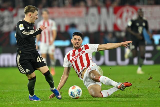 (260115) -- COLOGNE, Jan. 15, 2026 (Xinhua) -- Lennart Karl (L) of FC Bayern Munich vies with Cenk Oezkacar of FC Cologne during the German first division Bundesliga football match between FC Cologne and FC Bayern Munich in Cologne, Germany, Jan. 14, 2026. (Photo by Ulrich Hufnagel/Xinhua)