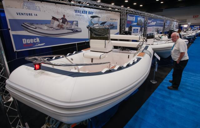 (260115) -- VANCOUVER, Jan. 15, 2026 (Xinhua) -- A man looks at an inflatable speedboat on display during the Vancouver International Boat Show 2026 at the Vancouver Convention Centre in Vancouver, British Columbia, Canada, Jan. 14, 2026. The five-day show kicked off here on Wednesday, with hundreds of exhibitors from around the world showcasing the latest vessels, marine gears and marine technology. (Photo by Liang Sen/Xinhua)