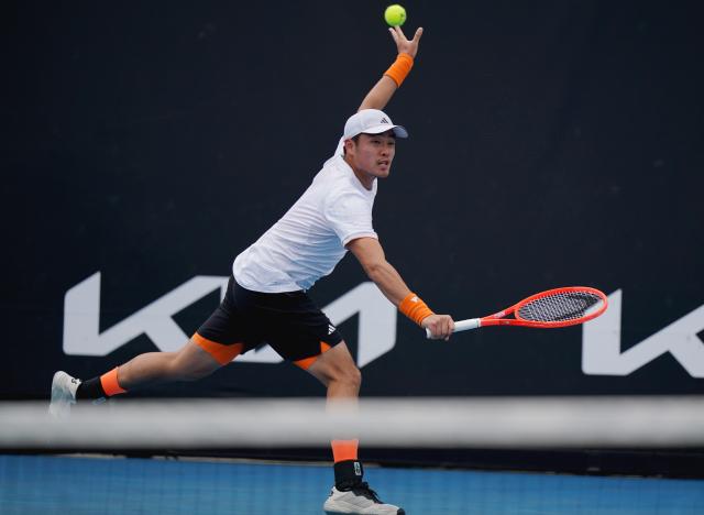 (260115) -- MELBOURNE, Jan. 15, 2026 (Xinhua) -- Wu Yibing of China hits a return during the men's singles qualifying final round match against Tristan Boyer of the United States at Australian Open tennis tournament in Melbourne, Australia, Jan. 15, 2026. (Photo by Wang Shen/Xinhua)