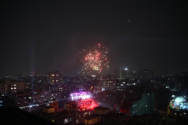 (260115) -- DHAKA, Jan. 15, 2026 (Xinhua) -- This photo taken on Jan. 14, 2026 shows coloured lights and exploding fireworks in the celebrations of the Sakrain festival in Dhaka, Bangladesh. People in Dhaka celebrated Sakrain festival, also known as Ghuri Utsob or Kite festival, at the end of Poush, the ninth month of the Bengali calendar. (Photo by Habibur Rahman/Xinhua)
