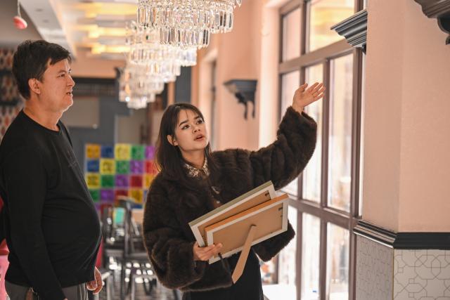 (260115) -- MOYU, Jan. 15, 2026 (Xinhua) -- Muyassar Ahmattohti (R) designs decorations with mulberry paper elements for a mulberry paper-themed restaurant in Purgakqi Town of Moyu County, northwest China's Xinjiang Uygur Autonomous Region, on Jan. 12, 2026. Muyassar Ahmattohti, who graduated from Xinjiang Arts University in 2025, returned to her hometown and became a designer of cultural and creative products of mulberry paper, a national intangible cultural heritage with a history of over a thousand years.
   A mulberry paper cultural industrial park was built and put into operation in Moyu County in 2025, which integrates cultural display, creative incubation and tourism, providing a brand-new platform for the inheritance of mulberry paper. 
   In the industrial park, Muyassar has her own space for creation on mulberry paper, and meanwhile, by shooting short videos and other means, she is able to bring the mulberry paper into the view of more people.
   Muyassar's design inspiration comes from the natural elements around her and the traditional culture of her hometown. In her hands, this ancient craftsmanship is no longer staying silent but has been transformed into wearable patterns, light installations, and other companions for people. 
   "Every time the brush touches the mulberry paper, I can feel that I have connected the past and future of my hometown," said Muyassar. (Xinhua/Ding Lei)
