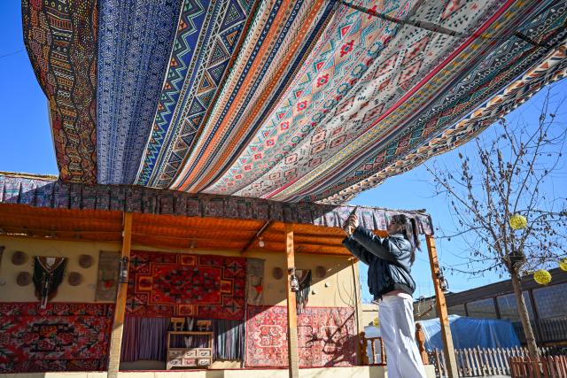 (260115) -- MOYU, Jan. 15, 2026 (Xinhua) -- Muyassar Ahmattohti takes photos of materials for creation at a village in Purgakqi Town of Moyu County, northwest China's Xinjiang Uygur Autonomous Region, on Jan. 13, 2026. Muyassar Ahmattohti, who graduated from Xinjiang Arts University in 2025, returned to her hometown and became a designer of cultural and creative products of mulberry paper, a national intangible cultural heritage with a history of over a thousand years.
   A mulberry paper cultural industrial park was built and put into operation in Moyu County in 2025, which integrates cultural display, creative incubation and tourism, providing a brand-new platform for the inheritance of mulberry paper. 
   In the industrial park, Muyassar has her own space for creation on mulberry paper, and meanwhile, by shooting short videos and other means, she is able to bring the mulberry paper into the view of more people.
   Muyassar's design inspiration comes from the natural elements around her and the traditional culture of her hometown. In her hands, this ancient craftsmanship is no longer staying silent but has been transformed into wearable patterns, light installations, and other companions for people. 
   "Every time the brush touches the mulberry paper, I can feel that I have connected the past and future of my hometown," said Muyassar. (Xinhua/Ding Lei)