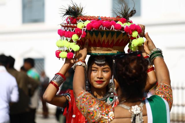 (260115) -- KATHMANDU, Jan. 15, 2026 (Xinhua) -- A girl prepares before taking part in a parade celebrating the Maghe Sankranti Festival in Kathmandu, Nepal, Jan. 15, 2026. Nepali Hindus celebrate the festival across the country, during which people take a ritual bath at river confluences, offer prayers at temples and enjoy traditional delicacies. (Photo by Sulav Shrestha/Xinhua)