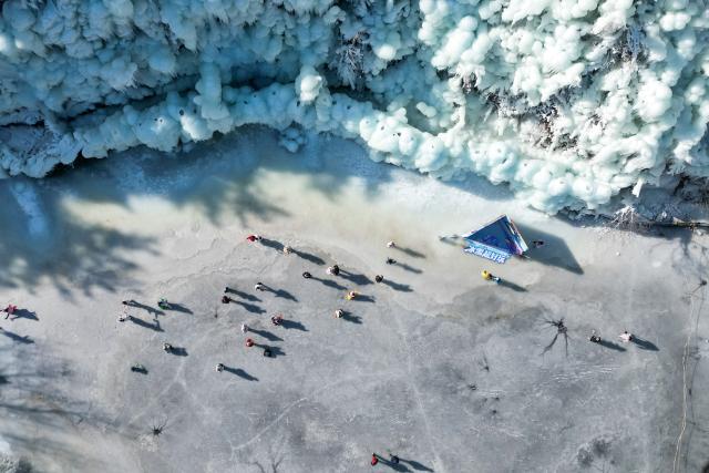 (260115) -- BEIJING, Jan. 15, 2026 (Xinhua) -- An aerial drone photo shows people having fun on a frozen lake at Jiuru mountain scenic spot in Jinan City, east China's Shandong Province, Jan. 13, 2026. (Photo by Hao Xincheng/Xinhua)