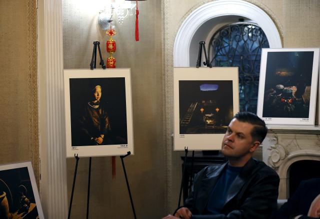 (260115) -- LONDON, Jan. 15, 2026 (Xinhua) -- A man takes part in "The Beauty of Low Light" photography exhibition in London, Britain, Jan. 15, 2026. The exhibition presented a selection of photographic works focusing on China's culture and natural landscapes, captured under low-light conditions. (Xinhua/Li Ying)