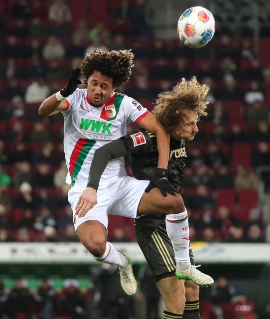 (251216) -- AUGSBURG, Dec. 16, 2025 (Xinhua) -- Han-Noah Massengo (L) of FC Augsburg and Alex Kral of 1. FC Union Berlin head for the ball during the German first division Bundesliga football match between FC Augsburg and 1. FC Union Berlin in Augsburg, Germany, Jan. 15, 2026. (Photo by Philippe Ruiz/Xinhua)