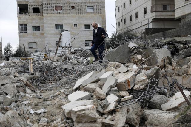 (260116) -- HEBRON, Jan. 16, 2026 (Xinhua) -- A Palestinian checks the rubble of a house demolished by the Israeli forces in the city of Hebron, southern West Bank, on Jan. 15, 2026. Israeli authorities arrested 80 Palestinians, demolished a house, and barred the Palestinian Authority's minister of Jerusalem affairs from entering the West Bank, according to Palestinian sources on Thursday. (Photo by Mamoun Wazwaz/Xinhua)