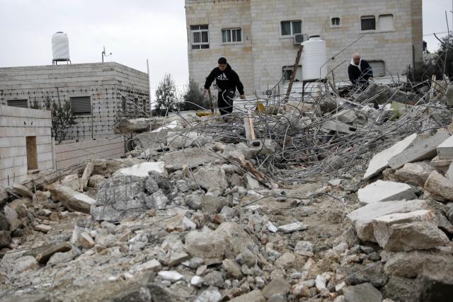 (260116) -- HEBRON, Jan. 16, 2026 (Xinhua) -- A Palestinian checks the rubble of a house demolished by the Israeli forces in the city of Hebron, southern West Bank, on Jan. 15, 2026. Israeli authorities arrested 80 Palestinians, demolished a house, and barred the Palestinian Authority's minister of Jerusalem affairs from entering the West Bank, according to Palestinian sources on Thursday. (Photo by Mamoun Wazwaz/Xinhua)