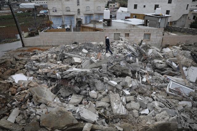 (260116) -- HEBRON, Jan. 16, 2026 (Xinhua) -- A Palestinian checks the rubble of a house demolished by the Israeli forces in the city of Hebron, southern West Bank, on Jan. 15, 2026. Israeli authorities arrested 80 Palestinians, demolished a house, and barred the Palestinian Authority's minister of Jerusalem affairs from entering the West Bank, according to Palestinian sources on Thursday. (Photo by Mamoun Wazwaz/Xinhua)