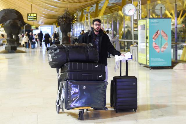 (260116) -- MADRID, Jan. 16, 2026 (Xinhua) -- A man carrying his luggage is pictured at the Adolfo Suarez Madrid-Barajas Airport in Madrid, Spain, on Jan. 15, 2026. A total of 97 million foreign tourists visited Spain in 2025, setting a new all-time record for international visitors to the country, Spanish Minister of Industry and Tourism Jordi Hereu announced on Thursday. (Photo by Gustavo Valiente/Xinhua)