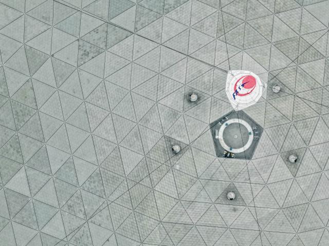 (260116) -- GUIYANG, Jan. 16, 2026 (Xinhua) -- An aerial drone photo taken on Jan. 16, 2026 shows the feed cabin of China's Five-hundred-meter Aperture Spherical Radio Telescope (FAST) under maintenance in southwest China's Guizhou Province. Through studying the observation data of China's gigantic radio telescope located in the country's southwestern Guizhou Province, an international research team has uncovered compelling new evidence supporting a binary-system origin for at least some fast radio bursts, one of the most enigmatic phenomena in modern astrophysics.
   These findings made by the research team, led by astronomers from the Purple Mountain Observatory of the Chinese Academy of Sciences, are based on observations using FAST, and have been published online in the journal Science. (Xinhua/Ou Dongqu)