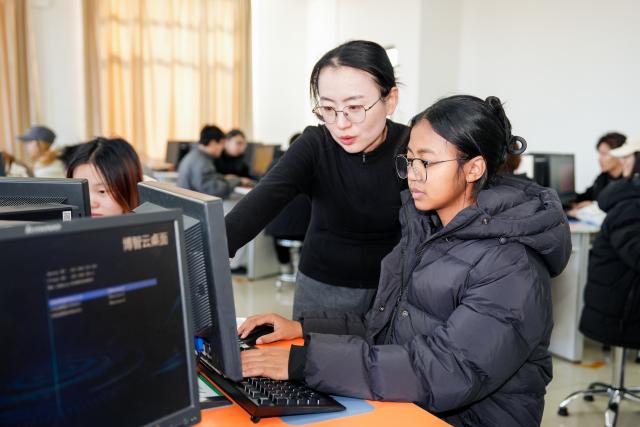 (260116) -- TIANJIN, Jan. 16, 2026 (Xinhua) -- A teacher instructs Dimbin'ny Riana Fitiavana Mamelasoa during a class in Tianjin, north China, Jan. 6, 2026. TO GO WITH "China Focus: China's Luban Workshop in Madagascar fuels local skills development" (Tianjin Vocational College of Mechanics and Electricity/Handout via Xinhua)