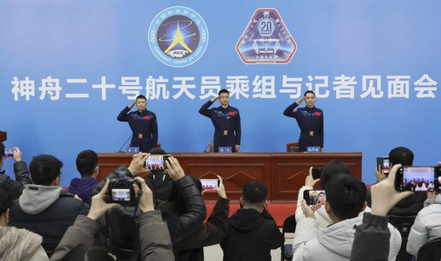 (260116) -- BEIJING, Jan. 16, 2026 (Xinhua) -- Astronauts Chen Dong (C), Chen Zhongrui (R) and Wang Jie from China's Shenzhou-20 crewed mission salute during a press conference in Beijing, capital of China, Jan. 16, 2026. The three astronauts met the press on Friday, their first public appearance after returning to Earth in November, 2025. (Xinhua/Li Minggang)