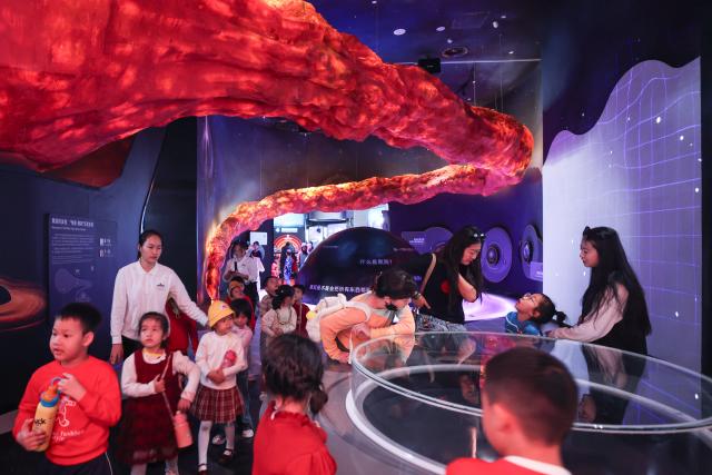 (260116) -- HAIKOU, Jan. 16, 2026 (Xinhua) -- People visit the Hainan Science and Technology Museum in Haikou, south China's Hainan Province, Jan. 15, 2026. The Hainan Science and Technology Museum has recently kicked off trial operation, drawing numerous families and science fans to explore the immersive and hands-on exhibits there.
   A brand-new landmark for science popularization in the Hainan Free Trade Port, the museum in a spiraling "auspicious cloud" design boasts a total construction area of approximately 46,500 square meters. It highlights Hainan's advantages in innovation, showcases local technological achievements, and reflects the integration of ecology and technology. (Xinhua/Zhang Liyun)