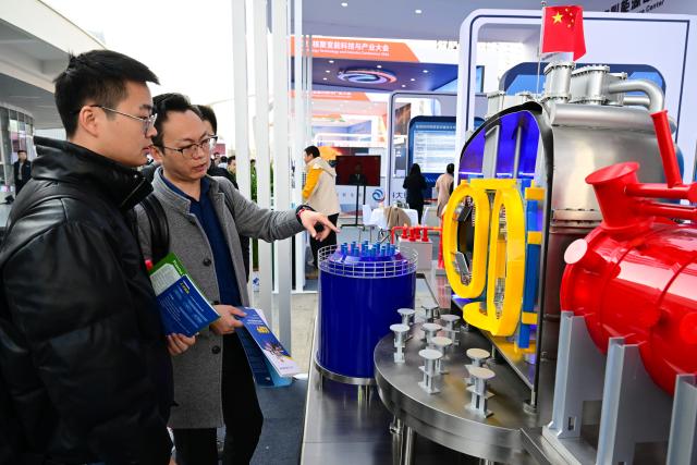 (260116) -- HEFEI, Jan. 16, 2026 (Xinhua) -- People view a model of the Experimental Advanced Superconducting Tokamak (EAST) during the Fusion Energy Technology and Industry Conference 2026 in Hefei, east China's Anhui Province, Jan. 16, 2026. The conference is held here from Jan. 16 to Jan. 17, which aims to build a collaborative and progressive innovation and industrial ecosystem for nuclear fusion energy. (Xinhua/Zhou Mu)