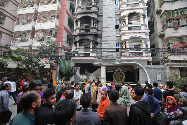 (260116) -- DHAKA, Jan. 16, 2026 (Xinhua) -- People gather near a residential building where a fire broke out in Dhaka, Bangladesh, Jan. 16, 2026. At least 6 people were killed and 13 others injured after a fierce fire tore through a residential building in the Bangladeshi capital, Dhaka, on Friday morning. (Photo by Habibur Rahman/Xinhua)