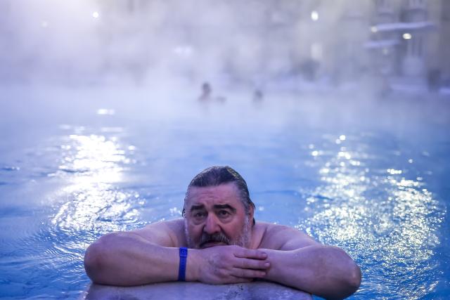 (260116) -- BUDAPEST, Jan. 16, 2026 (Xinhua) -- A man enjoys a thermal bath in the open air pool at the Szechenyi Thermal Bath in Budapest, Hungary on Jan. 16, 2026. (Photo by David Balogh/Xinhua)