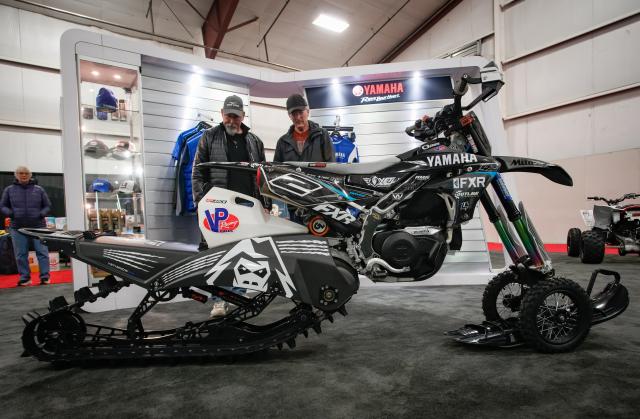 (260117) -- ABBOTSFORD, Jan. 17, 2026 (Xinhua) -- People look at a snow motorcycle during the 2026 BC Motorcycle and Powersports Show in Abbotsford, British Columbia, Canada, on Jan. 16, 2026. The three-day event kicked off here on Friday, featuring the latest motorcycles, cruisers, off-road bikes, All-Terrain Vehicles (ATV), and electric-powered vehicles. (Photo by Liang Sen/Xinhua)