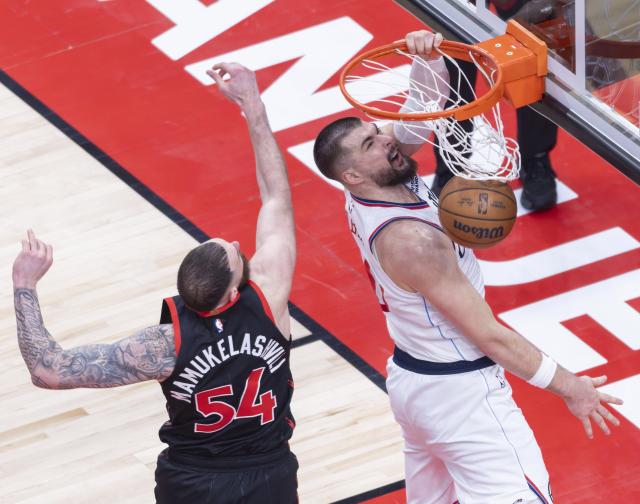 (260117) -- TORONTO, Jan. 17, 2026 (Xinhua) -- Ivica Zubac (R) of Los Angeles Clippers dunks during the 2025-2026 NBA regular season game between Toronto Raptors and Los Angeles Clippers in Toronto, Canada, on Jan. 16, 2026. (Photo by Zou Zheng/Xinhua)