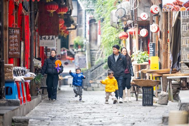 (260117) -- CHONGQING, Jan. 17, 2026 (Xinhua) -- Tourists visit the Wujiang River and Gongtan tourist resort in Youyang Tujia and Miao Autonomous County, southwest China's Chongqing Municipality, on Jan. 17, 2026. Located in the renowned Wujiang River Scenic Area and the Gongtan Ancient Town, the Wujiang River and Gongtan tourist resort has leveraged its abundant cultural heritage and unique natural landscapes to  enhance its appeal in recent years. 
   This has been achieved by diverse attractions such as boutique homestays, sightseeing cruises, art galleries, authentic folk cuisine, and intangible cultural heritage performances. 
   In 2025, the resort received over 5.04 million visitor trips and gained a total revenue of 2.818 billion yuan (about 404.37 million U.S. dollars). (Xinhua/Tang Yi)
