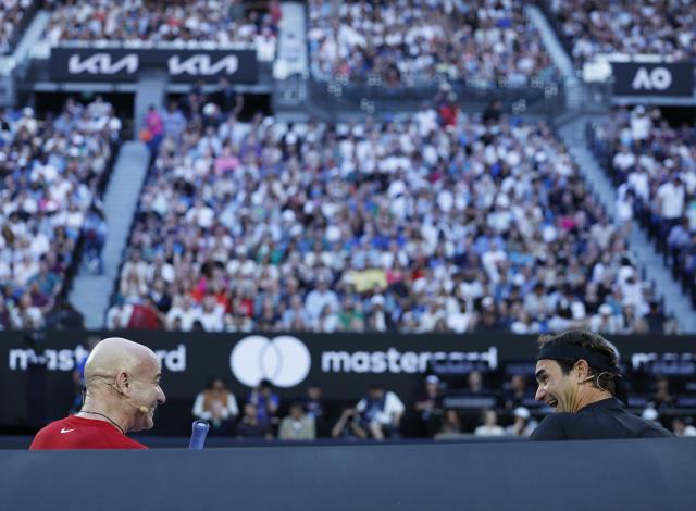 (260117) -- MELBOURNE, Jan. 17, 2026 (Xinhua) -- Former tennis players Roger Federer (R) of Switzerland and Andre Agassi of the United States communicate during the opening ceremony exhibition match at the 2026 Australian Open at Melbourne Park in Melbourne, Australia, Jan. 17, 2026. (Xinhua/Ma Ping)