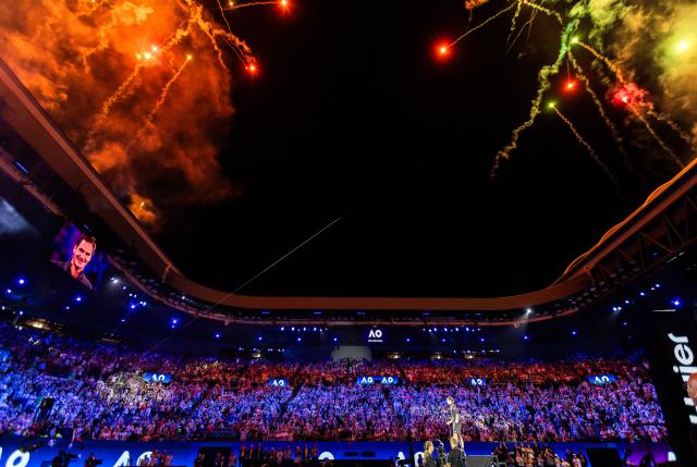 (260117) -- MELBOURNE, Jan. 17, 2026 (Xinhua) -- Former tennis player Roger Federer of Switzerland speaks as fireworks explode after the opening ceremony exhibition match at the 2026 Australian Open at Melbourne Park in Melbourne, Australia, Jan. 17, 2026. (Photo by Hu Jingchen/Xinhua)
