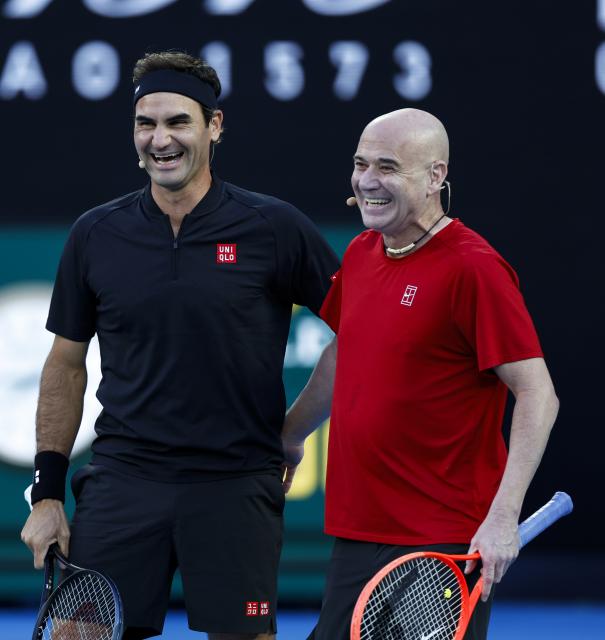 (260117) -- MELBOURNE, Jan. 17, 2026 (Xinhua) -- Former tennis players Roger Federer (L) of Switzerland and Andre Agassi of the United States react during the opening ceremony exhibition match at the 2026 Australian Open at Melbourne Park in Melbourne, Australia, Jan. 17, 2026. (Xinhua/Ma Ping)