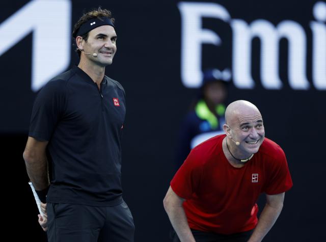 (260117) -- MELBOURNE, Jan. 17, 2026 (Xinhua) -- Former tennis players Roger Federer (L) of Switzerland and Andre Agassi of the United States react during the opening ceremony exhibition match at the 2026 Australian Open at Melbourne Park in Melbourne, Australia, Jan. 17, 2026. (Xinhua/Ma Ping)