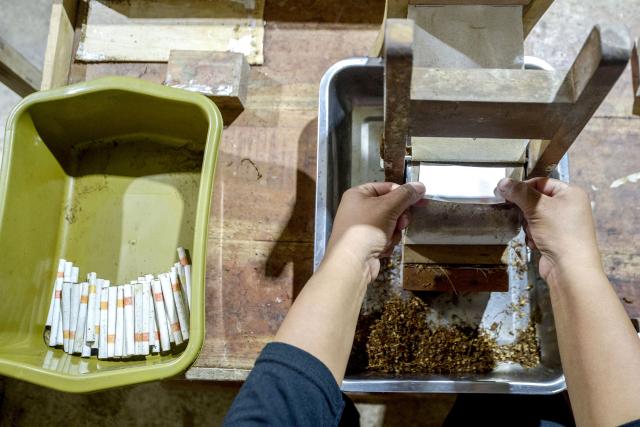 (260117) -- YOGYAKARTA, Jan. 17, 2026 (Xinhua) -- A worker makes cigarettes in Yogyakarta, Indonesia, Jan. 16, 2026. The Indonesian government plans to add one additional layer to the cigarette excise tariff structure this year as part of efforts to curb illegal tobacco distribution, Finance Minister Purbaya Yudhi Sadewa said on Jan. 14. (Photo by Agung Supriyanto/Xinhua)