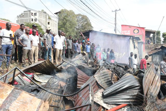 (260117) -- NAIROBI, Jan. 17, 2026 (Xinhua) -- People gather around the debris of houses burned down during a fire at Kibera slum in Nairobi, Kenya, on Jan. 17, 2026. A fire broke out here on Saturday, causing dozens of houses burned down. No casualties have been reported yet. (Photo by Henry Naminde/Xinhua)
