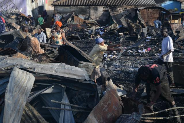 (260117) -- NAIROBI, Jan. 17, 2026 (Xinhua) -- People clean the debris of houses burned down during a fire at Kibera slum in Nairobi, Kenya, on Jan. 17, 2026. A fire broke out here on Saturday, causing dozens of houses burned down. No casualties have been reported yet. (Xinhua/Yang Guang)