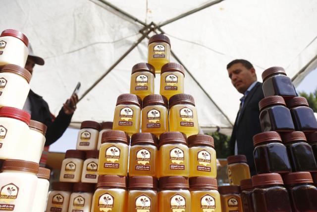 (260118) -- SANAA, Jan. 18, 2026 (Xinhua) -- A honey seller displays a variety of honey products for sale during the annual Yemeni honey festival in Sanaa, Yemen, on Jan. 17, 2026. The annual Yemeni honey festival themed "Yemen, the Home of Honey," was held in Sanaa on Saturday, aiming to uphold its status as one of the nation's most significant products, valued for its nutrition and economic benefits. (Photo by Mohammed Mohammed/Xinhua)