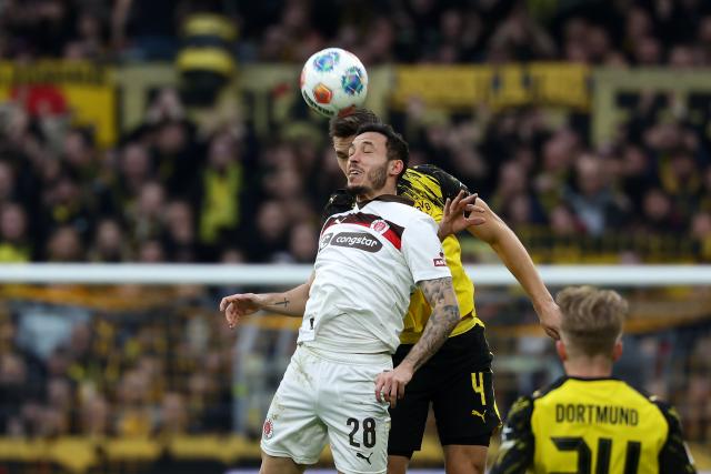 (260118) -- DORTMUND, Jan. 18, 2026 (Xinhua) -- Nico Schlotterbeck (rear) of Borussia Dortmund and Mathias Pereira Lage of FC St. Pauli head for the ball during the German first division Bundesliga football match between Borussia Dortmund and FC St. Pauli in Dortmund, Germany, Jan. 17, 2026. (Photo by Joachim Bywaletz/Xinhua)