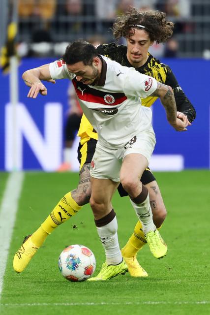 (260118) -- DORTMUND, Jan. 18, 2026 (Xinhua) -- Fabio Silva (rear) of Borussia Dortmund vies with Mathias Pereira Lage of FC St. Pauli during the German first division Bundesliga football match between Borussia Dortmund and FC St. Pauli in Dortmund, Germany, Jan. 17, 2026. (Photo by Joachim Bywaletz/Xinhua)