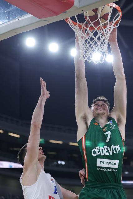 (260118) -- LJUBLJANA, Jan. 18, 2026 (Xinhua) -- Luka Brajkovic (R) of Cedevita Olimpija dunks the ball during the 15th round of the ABA Basketball League match between Cedevita Olimpija and Buducnost VOLI in Ljubljana, Slovenia, Jan.17, 2026. (Photo by Zeljko Stevanic/Xinhua)