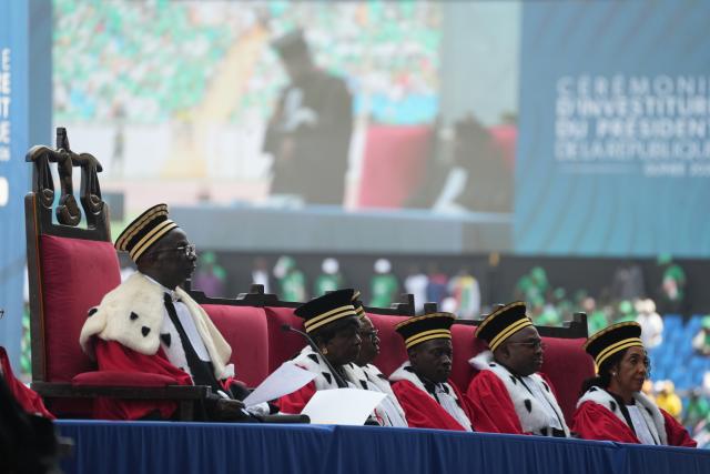 (260118) -- CONAKRY, Jan. 18, 2026 (Xinhua) -- Members of Guinea's Supreme Court witness president-elect Mamady Doumbouya taking the oath of office at the inauguration ceremony in Conakry, Guinea, Jan. 17, 2026. Mamady Doumbouya was officially sworn in as president of the Republic of Guinea for a seven-year term on Saturday, in accordance with the provisions of the country's new Constitution. (Xinhua/Zhang Jian)
