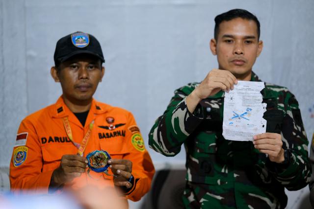(260118) -- SOUTH SULAWESI, Jan. 18, 2026 (Xinhua) -- Officials show a document and a small part after finding them near the site of a missing aircraft during a press conference in Maros Regency, South Sulawesi province, Indonesia, Jan. 17, 2026. Parts believed to be the fuselage and tail of an aircraft carrying 10 people that lost contact Saturday while flying from Yogyakarta to Makassar were found on Sunday in South Sulawesi, Indonesian local media reported. (Photo by Muchtamir Zaide/Xinhua)