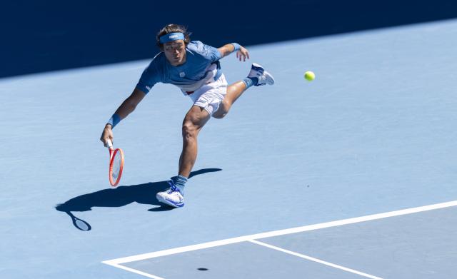 (260118) -- MELBOURNE, Jan. 18, 2026 (Xinhua) -- Zhang Zhizhen of China hits a return during the men's singles first round match between Zhang Zhizhen of China and Francisco Cerundolo of Argentina at the Australian Open tennis tournament 2026 in Melbourne, Australia, Jan. 18, 2026. (Photo by Hu Jingchen/Xinhua)