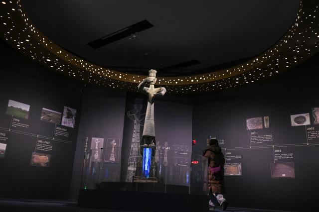 (260118) -- BEIJING, Jan. 18, 2026 (Xinhua) -- A visitor views a replica of bronze standing figure during an exhibition named "Ancient Shu Civilization of the Sanxingdui and Jinsha Sites" at the National Museum of China in Beijing, capital of China, Jan. 18, 2026. With more than 200 pieces (sets) of relics featuring ancient Shu civilization, the exhibition kicked off here on Sunday and will last until Aug. 18. (Xinhua/Jin Liangkuai)