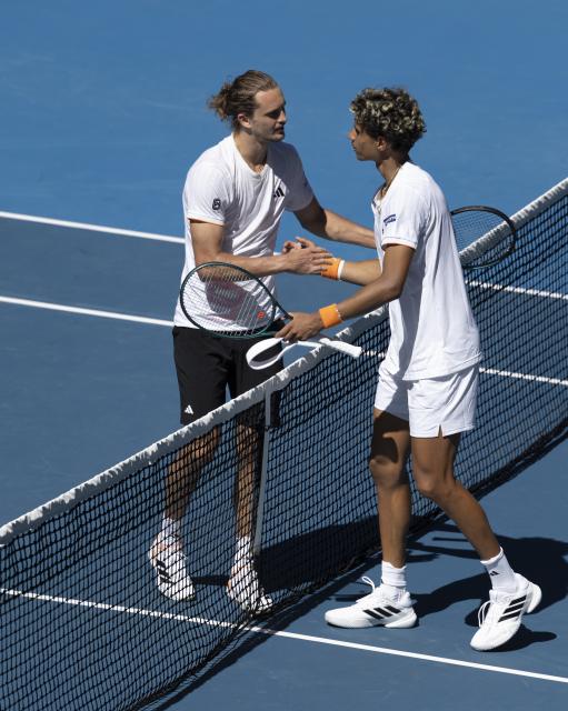 (260118) -- MELBOURNE, Jan. 18, 2026 (Xinhua) -- Alexander Zverev (L) and Gabriel Diallo shake hands after the men's singles 1st round match between Alexander Zverev of Germany and Gabriel Diallo of Canada at the Australian Open tennis tournament in Melbourne, Australia, Jan. 18, 2026. (Photo by Hu Jingchen/Xinhua)