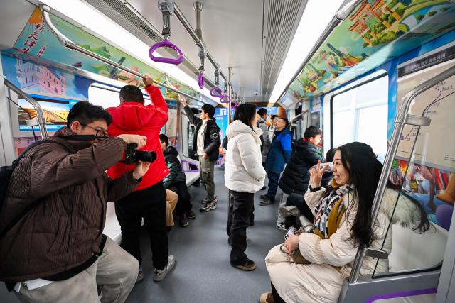 (260118) -- TIANJIN, Jan. 18, 2026 (Xinhua) -- Passengers take photos on a train of Tianjin Rail Transit Line Z4 in north China's Tianjin, on Jan. 18, 2026. The northern section of the first phase of Tianjin Rail Transit Line Z4 began operations on Sunday.
   The newly opened section spans 23.7 kilometers with 10 stations. Upon completion, the full Phase 1 line will cover a total length of 43.7 kilometers with 24 stations.
   As a backbone line linking the northern and southern parts of the Binhai New Area with its core district, the Z4 line is expected to play a vital role in optimizing the regional rail system and promoting integration. (Xinhua/Zhao Zishuo)