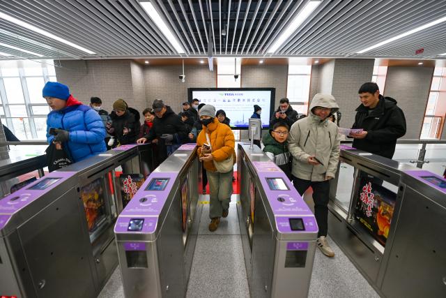 (260118) -- TIANJIN, Jan. 18, 2026 (Xinhua) -- Passengers walk through ticket gates at Beitang Station of Tianjin Rail Transit Line Z4 in north China's Tianjin, on Jan. 18, 2026. The northern section of the first phase of Tianjin Rail Transit Line Z4 began operations on Sunday.
   The newly opened section spans 23.7 kilometers with 10 stations. Upon completion, the full Phase 1 line will cover a total length of 43.7 kilometers with 24 stations.
   As a backbone line linking the northern and southern parts of the Binhai New Area with its core district, the Z4 line is expected to play a vital role in optimizing the regional rail system and promoting integration. (Xinhua/Zhao Zishuo)